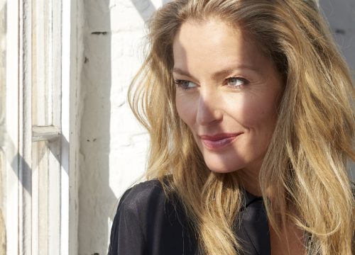 Woman with great skin after a brow lift staring out a window
