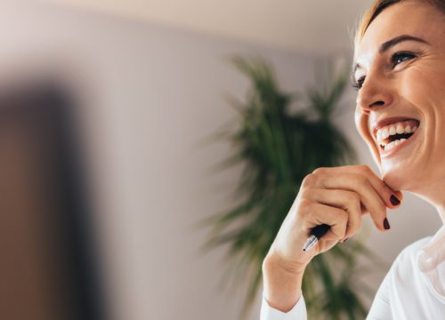 Happy woman at work after successful earlobe repair