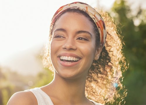 Happy woman after a non-surgical rhinoplasty treatment