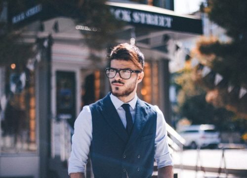 man wearing glasses and a vest