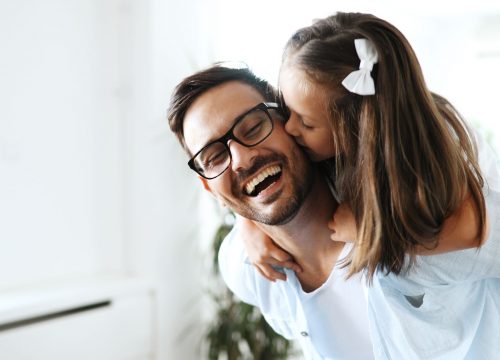 Little girl kissing her father